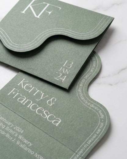 Sage green Verdura wedding invitation with a unique wavy edge and elegant white monogram on matte luxury paper.