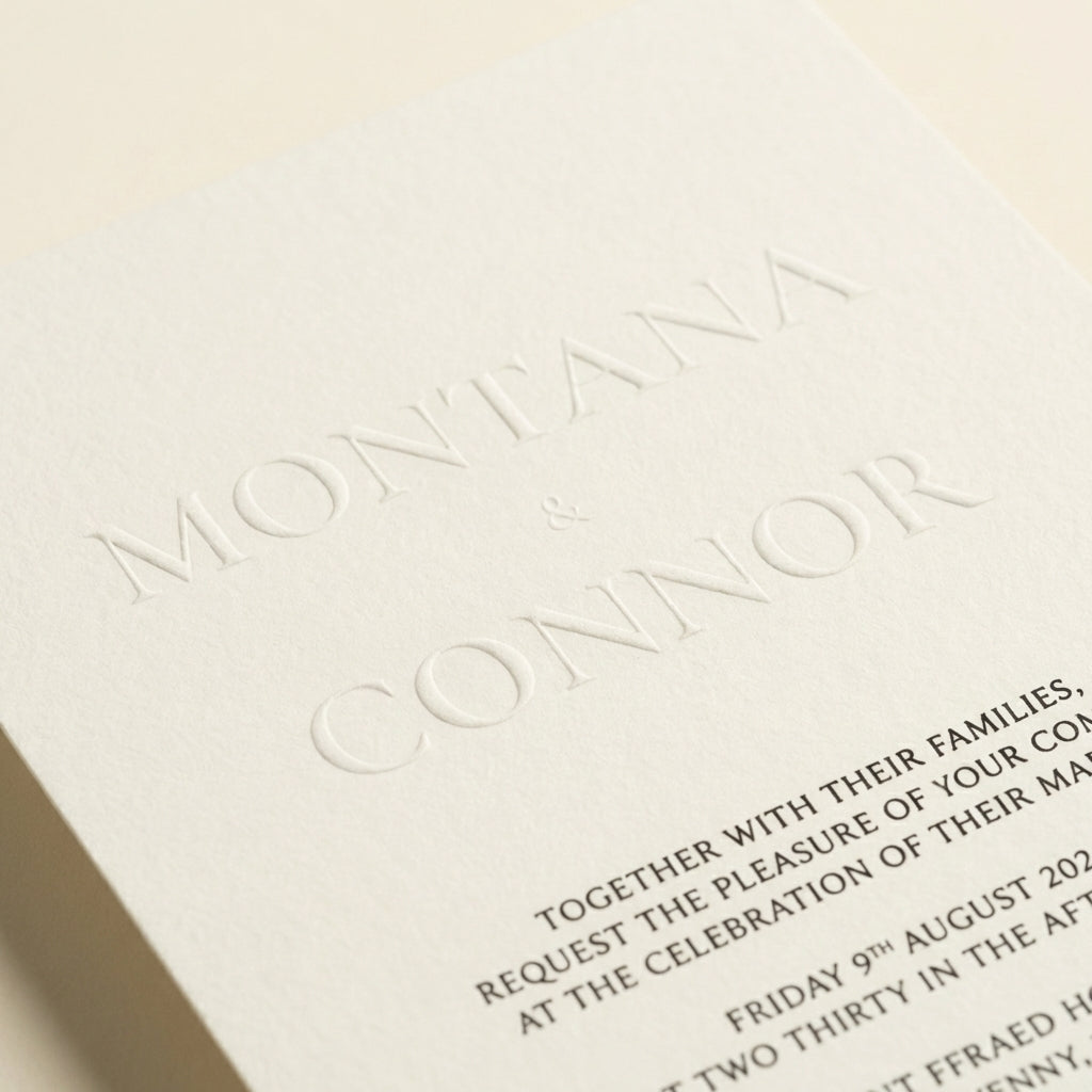 Close-up of the Althea wedding invitation featuring elegant embossed names on textured ivory luxury paper.