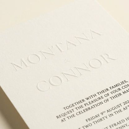 Close-up of the Althea wedding invitation featuring elegant embossed names on textured ivory luxury paper.