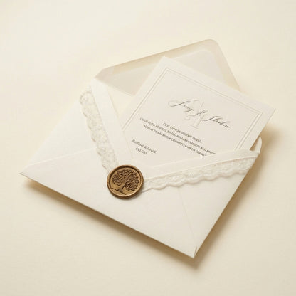 Celestia wedding invitation card inside a cream envelope with white lace trim and a gold tree of life wax seal.