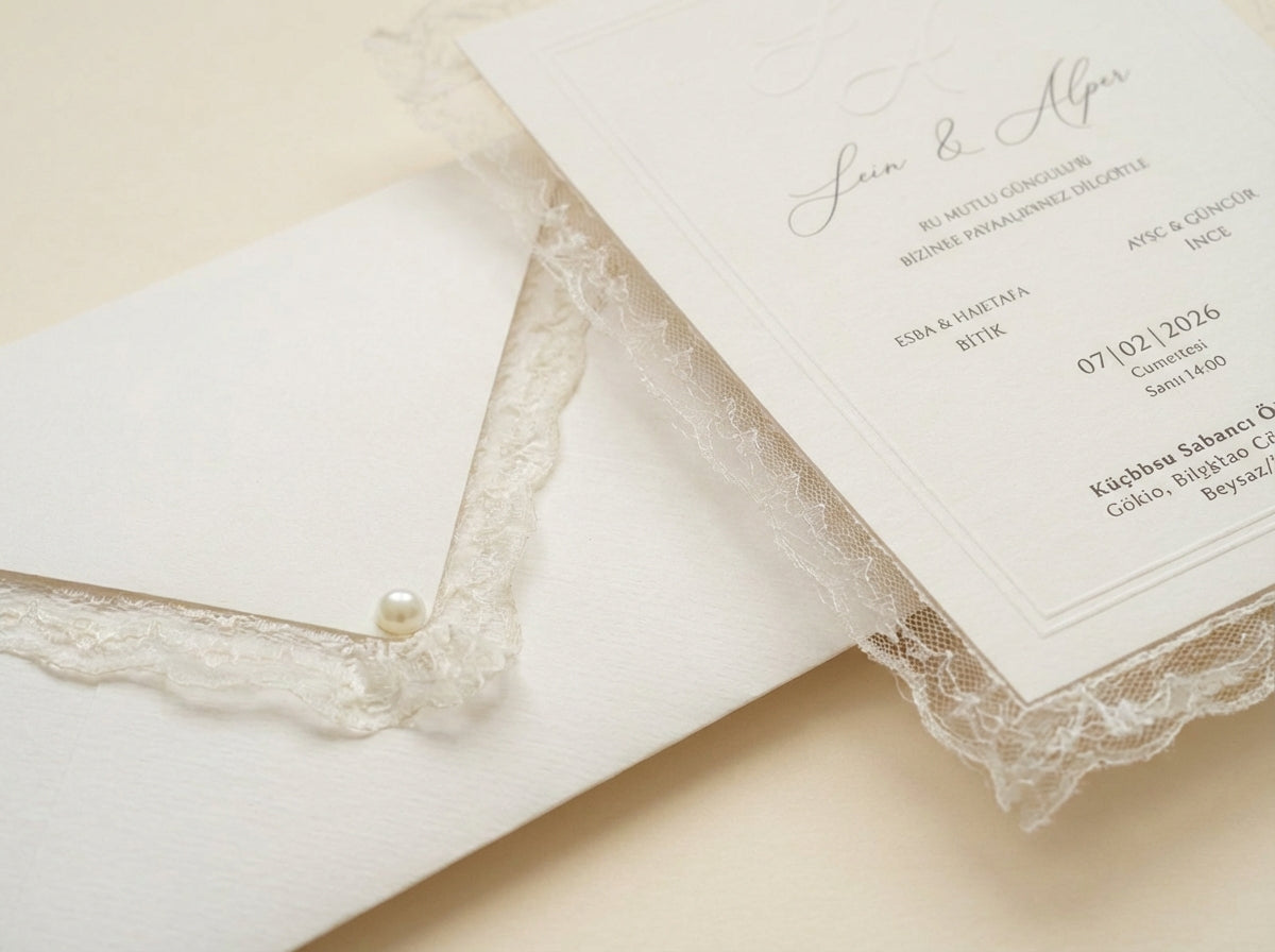 Veridia luxury wedding invitation featuring delicate lace trim, pearl detailing, and elegant cursive calligraphy.