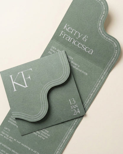 Verdura sage green wedding invitation featuring a unique wavy edge, monogram, and elegant typography on matte paper.